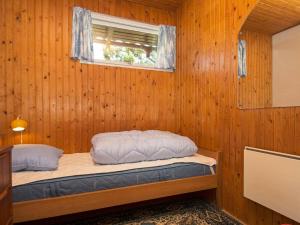 a bedroom with a bed in a wooden wall at 5 person holiday home in Silkeborg in Silkeborg