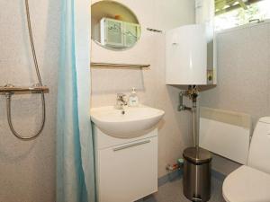 a bathroom with a sink and a toilet and a mirror at 5 person holiday home in Silkeborg in Silkeborg