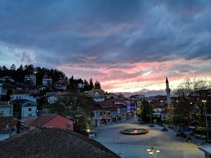 a view of a city at sunset with a town at Apartments Mostrovi in Ohrid