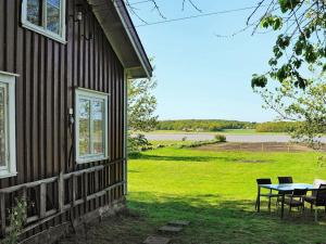 Kodeにある4 person holiday home in kodeの野原の景色を望む家の外のテーブルと椅子