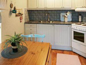 a kitchen with a wooden table and a sink at 5 person holiday home in FALKENBERG-By Traum in Falkenberg
