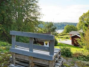 a wooden bench sitting on top of a hill at 5 person holiday home in LJUNGSKILE in Ljungskile