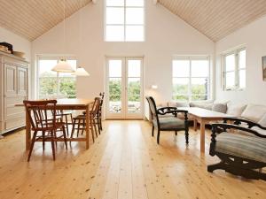 a living room with a table and a couch at 6 person holiday home in Store Fuglede in Store Fuglede