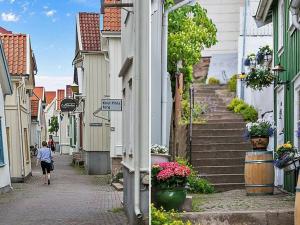 a woman walking down a street in a town at 6 person holiday home in BRASTAD in Brastad