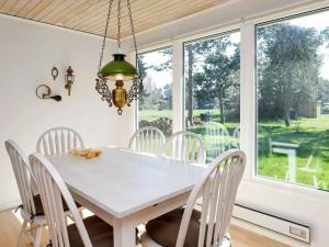 a dining room with a white table and chairs at Holiday home Rødby XIX in Rødby