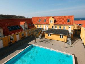 an overhead view of a house and a swimming pool at 6 person holiday home in Gudhjem in Gudhjem