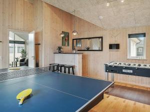 a kitchen with a ping pong table in a room at 10 person holiday home in Hasselberg in Kappeln