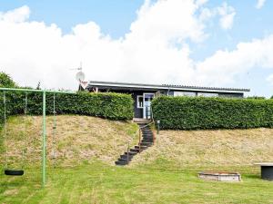 a house on top of a hill with at 4 person holiday home in Juelsminde in Sønderby