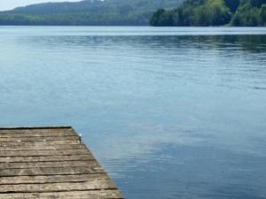 a view of a lake with a wooden dock at 4 person holiday home in Silkeborg in Silkeborg