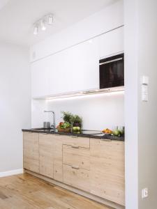 a kitchen with white walls and a wooden counter top at Górskie Klimaty Myśliwska in Karpacz