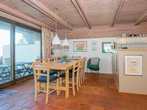a dining room with a wooden table and chairs at 8 person holiday home in Glesborg in Fjellerup