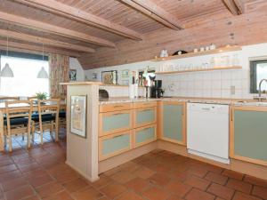 a kitchen with wooden ceilings and a dining room at 8 person holiday home in Glesborg in Fjellerup