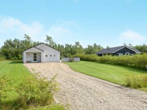 a gravel road leading to a white house at 6 person holiday home in Hemmet in Hemmet
