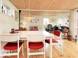 a kitchen and living room with a white table and chairs at 6 person holiday home in Store Fuglede in Store Fuglede