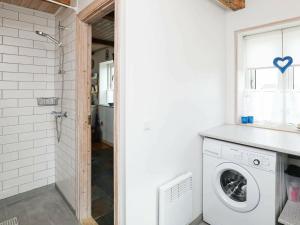 a laundry room with a washer and dryer at 6 person holiday home in Harbo re in Harboør