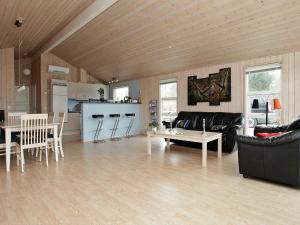 a living room with a couch and a table at 6 person holiday home in Dannemare in Dannemare