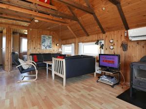 a living room with a couch and a tv at 6 person holiday home in Hvide Sande in Hvide Sande