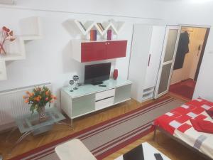 a living room with a tv on a white wall at Calea Victoriei Residence in Bucharest