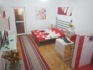 a bedroom with a bed with a red and white blanket at Calea Victoriei Residence in Bucharest