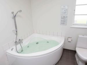 a bath tub in a bathroom with a toilet at 8 person holiday home in Nysted in Nysted
