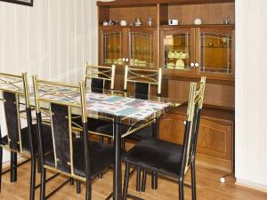 a dining room with a glass table and chairs at Two-Bedroom Holiday home in Vågland 4 in Rabben