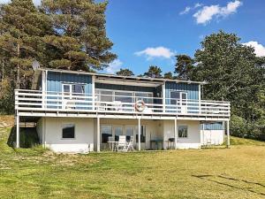 a large blue and white house on top of a field at 8 person holiday home in LJUNGSKILE in Ljungskile