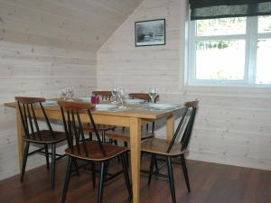 a dining room with a wooden table and chairs at 6 person holiday home in Åram-By Traum in Sandvik +25 photos