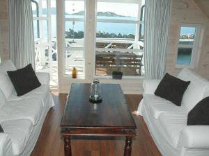 a living room with two white couches and a coffee table at 6 person holiday home in Åram-By Traum in Sandvik