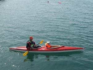two people in a red kayak in the water at 8 person holiday home in Kalvåg-By Traum in Kalvåg