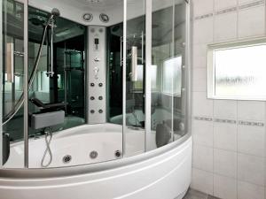 a bath tub in a bathroom with a window at 10 person holiday home in Ansager in Ansager