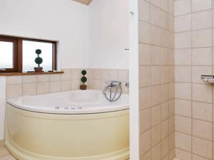 a bath tub in a bathroom with a window at 8 person holiday home in Ulfborg-By Traum in Thorsminde +18 photos
