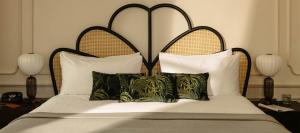 a bed with a large headboard and some pillows at The Hoxton, Downtown LA in Los Angeles