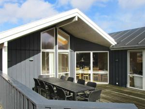 a patio with a table and chairs on a deck at 10 person holiday home in Harbo re in Harboør