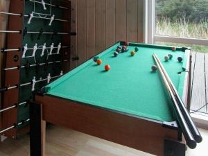 a green pool table with balls and cuesticks at 10 person holiday home in Harbo re in Harboør
