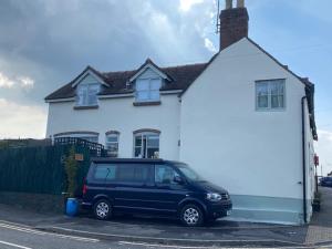 a blue van parked in front of a white house at Tallow House in Ludlow