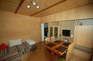 a room with a table and a couch and a dining room at Apartment Alena in Saalbach Hinterglemm