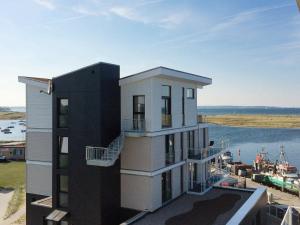 a building with a view of a body of water at 8 person holiday home in Wendtorf in Wendtorf