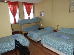 Postel nebo postele na pokoji v ubytování Hostal Residencia Blest Gana
