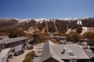 an aerial view of a small town with snow covered mountains at Snowgoose Apartments in Thredbo