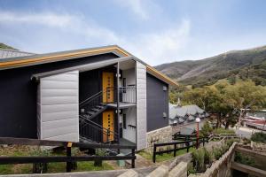 a small house with a large window at Snowgoose Apartments in Thredbo