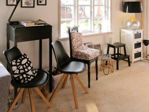 a living room with a piano and two chairs at Holiday home Vordingborg V in Vordingborg