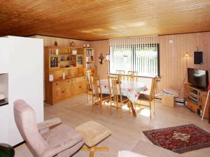 a kitchen and dining room with a table and chairs at 6 person holiday home in Hemmet in Falen