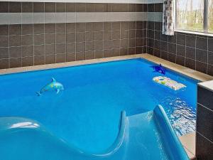 a swimming pool with two fish in the water at 18 person holiday home in Hasselberg in Kappeln