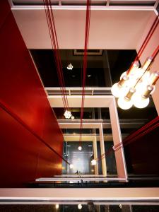 
a red light hanging from the ceiling of a building at Art Series - The Cullen in Melbourne
