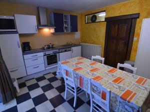 a kitchen with a table with chairs and a sink at Charming Holiday Home in Halleux with Garden in Halleux