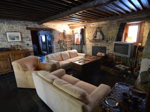 a living room with two couches and a television at Charming Holiday Home in Halleux with Garden in Halleux