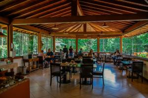 a large outdoor dining area with tables and chairs at Pousada Campos dos Holandeses - Campos do Jordao in Campos do Jordão