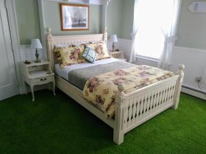 a bedroom with a white bed and a window at Splendor Inn Bed & Breakfast in Norwich