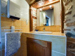 a bathroom with a sink and a mirror at Holiday Home Saint-Beauzire near Pauillac Castle in Saint-Beauzire