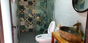 a bathroom with a toilet and a sink and a shower at Tavan Dragon House in Lao Cai